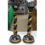 A pair of painted and gilded wood pricket candlest