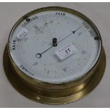 A brass cased barometer.