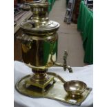 A Russian brass samovar on tray with drip bowl.