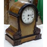 Carved walnut cased mantel clock.