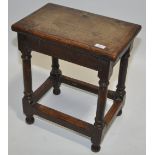 An Antique oak joint stool.