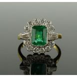 An 18ct gold emerald-cut emerald and diamond clust