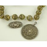 An ornate silver gilt filigree bauble bauble neckl