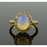 An 18ct gold cabochon opal and diamond cluster rin