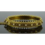 A 19th century unmarked gold hinged bangle, set wi