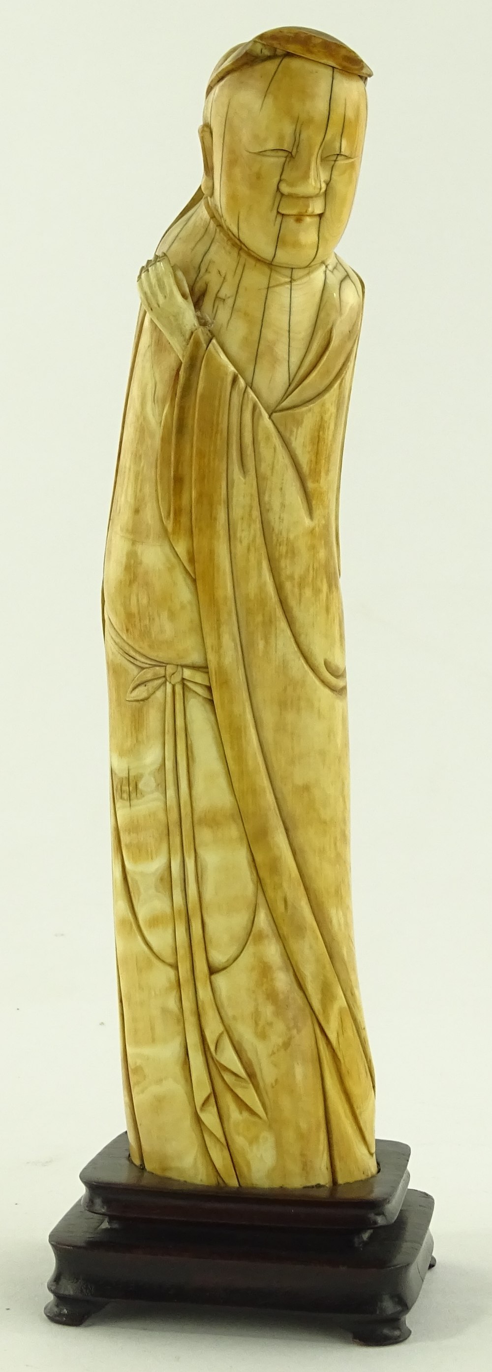 A 17th century carved ivory figure of a monk, with