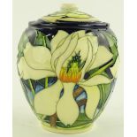 A Moorcroft pottery jar and cover with white flora