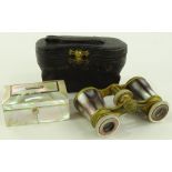 A cased pair of mother of pearl opera glasses and