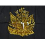 A silk banner with hand painted and gilded design