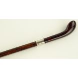 A simulated amber handled walking stick with silve