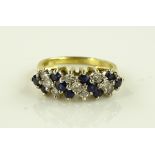 An 18ct gold ring set with bands of sapphires and