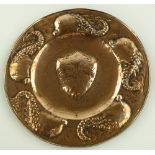 A Newlyn Arts & Crafts copper charger, relief embo