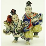 A Japanese Satsuma porcelain group, 2 dancing musi