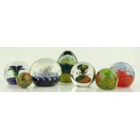 A group of 7 glass paperweights, including Jablows