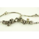 2 silver Pandora charm bracelets with 12 charms.