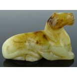 A Chinese carved white and russet jade recumbent h