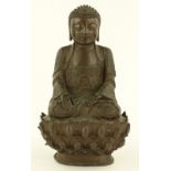 A Chinese patinated bronze seated Buddha, probably