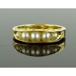 An 18ct gold and 5 pearl set ring, engraved settin