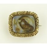 An unmarked gold ornate hair panel memorial brooch