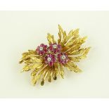 An 18ct gold ruby and diamond set flower brooch, b