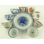 A group of Chinese porcelain tea bowls and dishes.