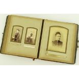A Victorian leather photograph album, containing m