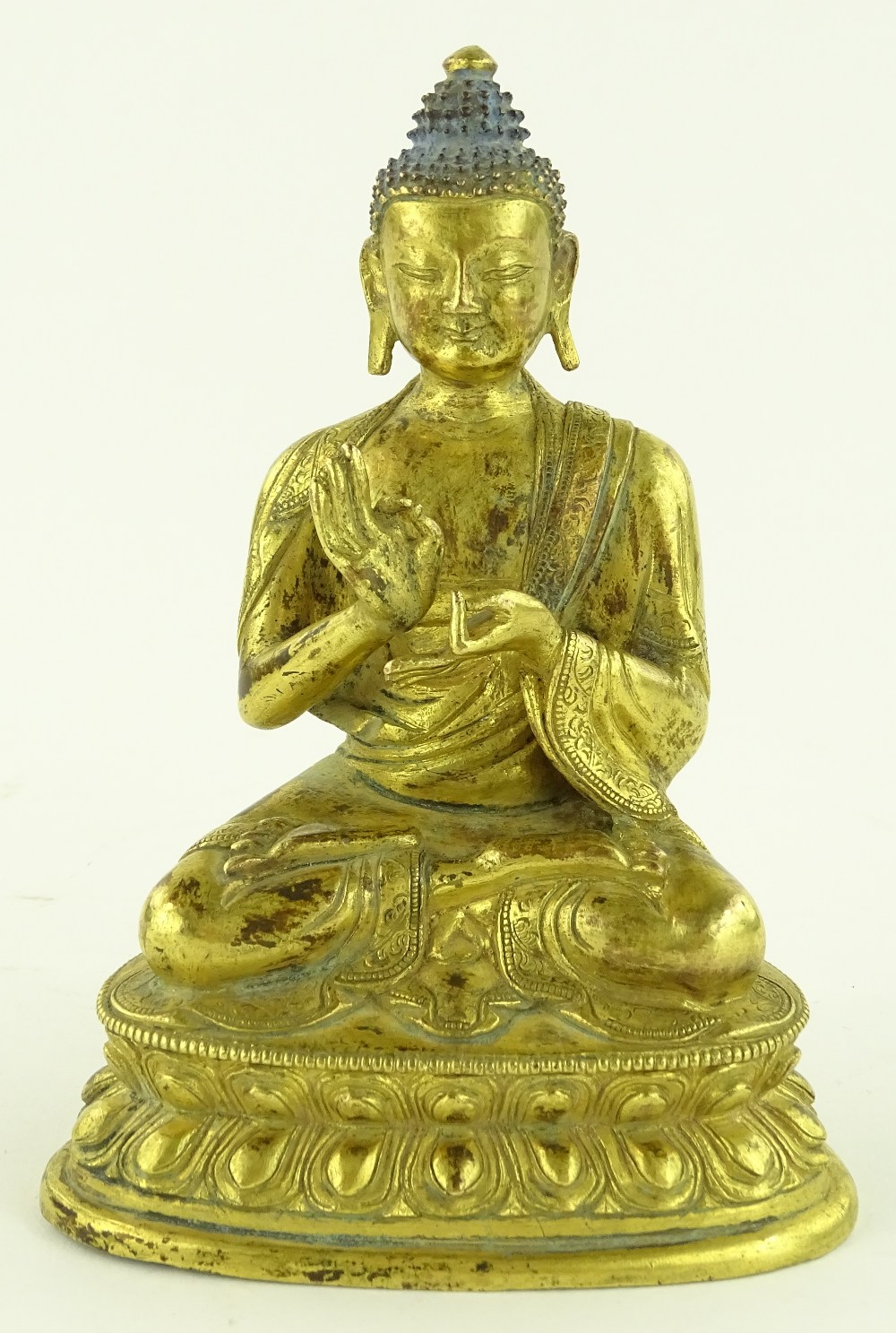 An Oriental gilt bronze seated Buddha, height 15c