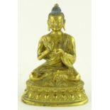 An Oriental gilt bronze seated Buddha, height 15c