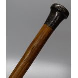A walking cane with silver knop.