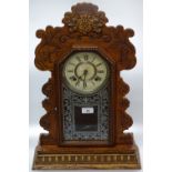 A carved oak cased 2-train mantel clock.