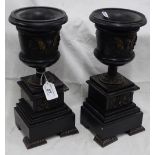 Pair of gilded black slate pedestals.