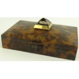 A tortoiseshell box circa 1900, the lid surmounted