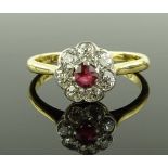 An 18ct gold and platinum ruby and diamond flowerh