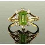 An 18ct gold peridot and diamond cluster ring, set