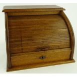 A walnut roll front stationery box, tambour front