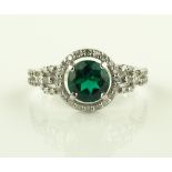 A 14ct white gold emerald and diamond cluster ring