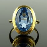 A 9ct gold oval aquamarine set ring, bezel set aqu