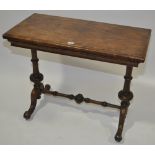 A Victorian walnut foldover card table on stretche