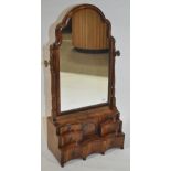 An Antique walnut toilet mirror with cushion frame