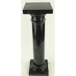 A black marble pedestal column, height 74cm, width