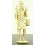 A Japanese Meiji period carved ivory fisherman, he