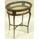 An Edwardian oval mahogany vitrine table, 23" acro