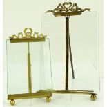 A pair of photo frames with cast ribbon mounts, la