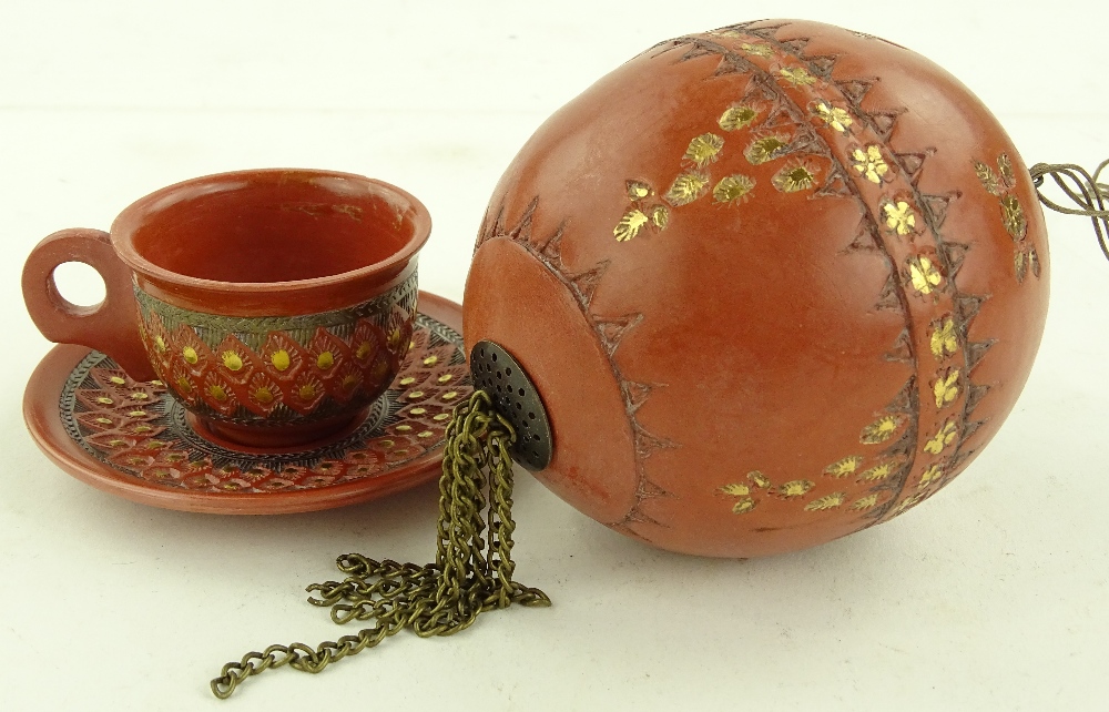 A Turkish gilded pottery coffee cup and saucer and