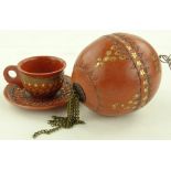 A Turkish gilded pottery coffee cup and saucer and