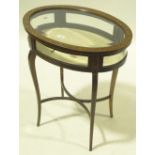 An Edwardian oval mahogany vitrine table, inlaid a