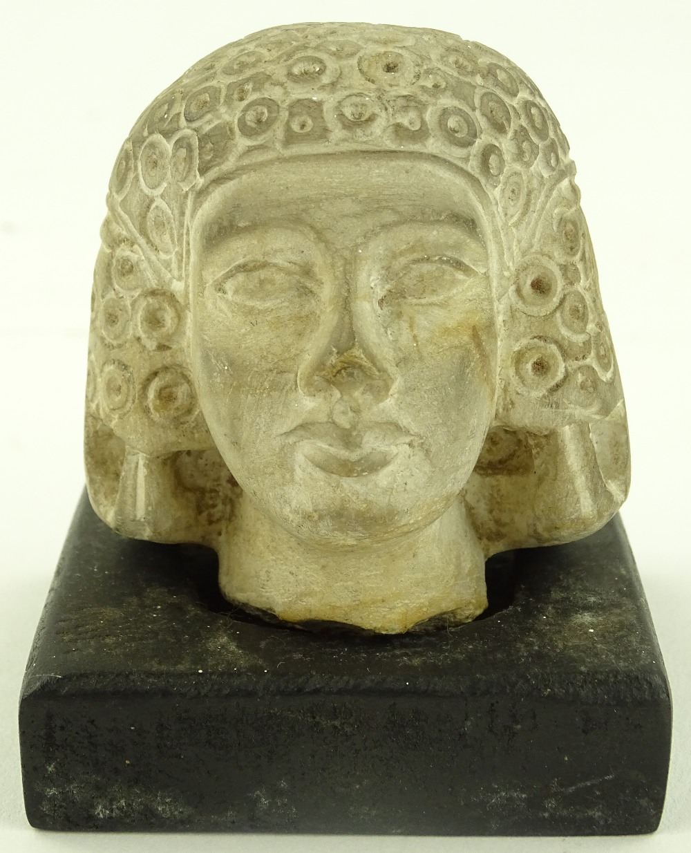 An Ancient Egyptian carved limestone female head,