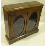 A Victorian walnut pier cabinet, 2 oval glass pane