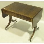 An early 19th century rosewood sofa table, inlaid