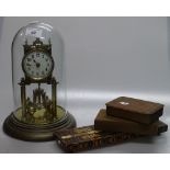 A brass 400-day mantel clock under-glass dome, a F